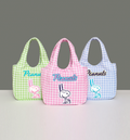 Three gingham bags with 'Peanuts' branding on a gray background