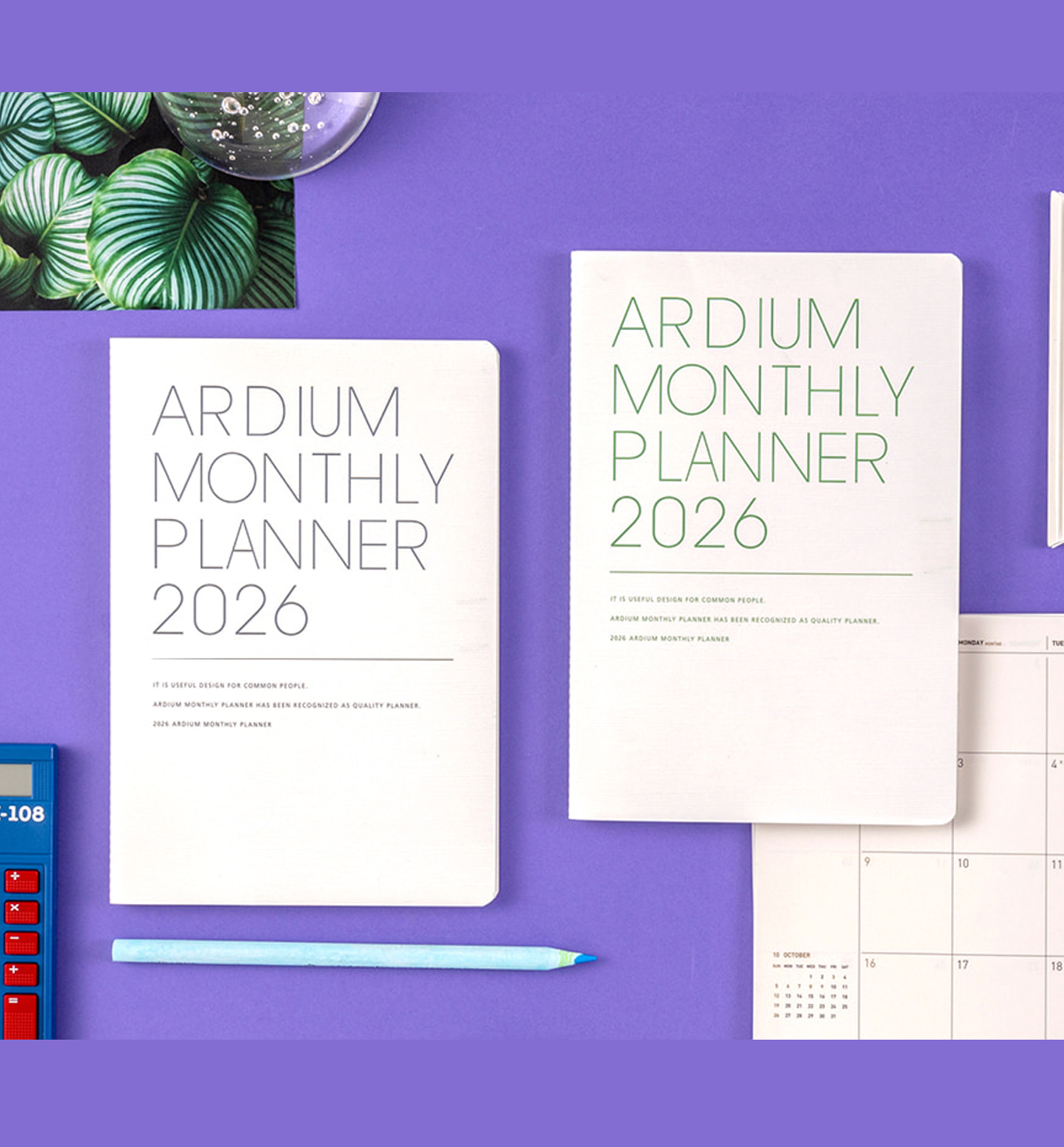 Ardium Monthly Planner 2026 on a purple surface with a pen and plant.